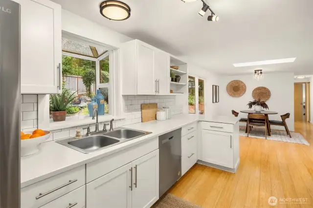 The approach from the dining room: light and bright, the angled galley style kitchen makes cooking easy.