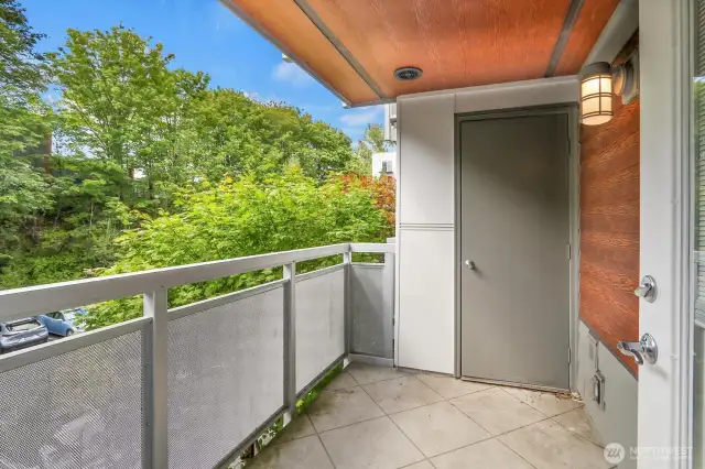 Sunny balcony overlooks the parking lot.
