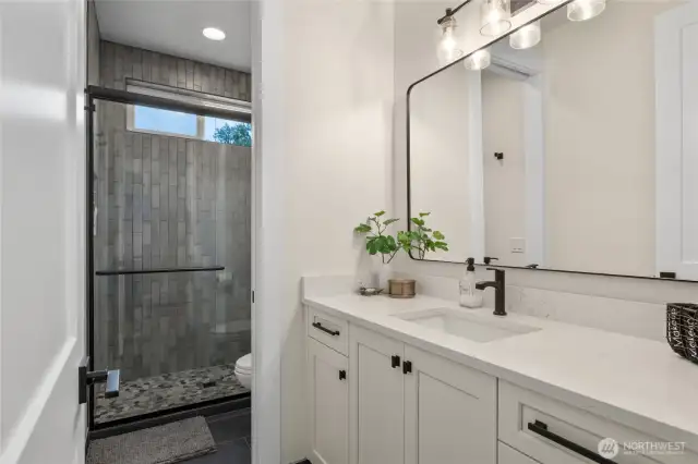 Three quarter bathroom in between the guestrooms.