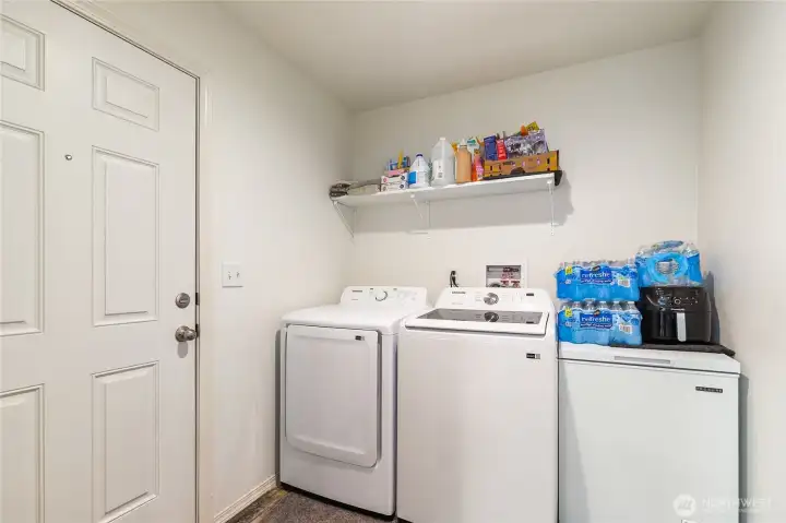 Laundry located just off the kitchen and leads to the backyard