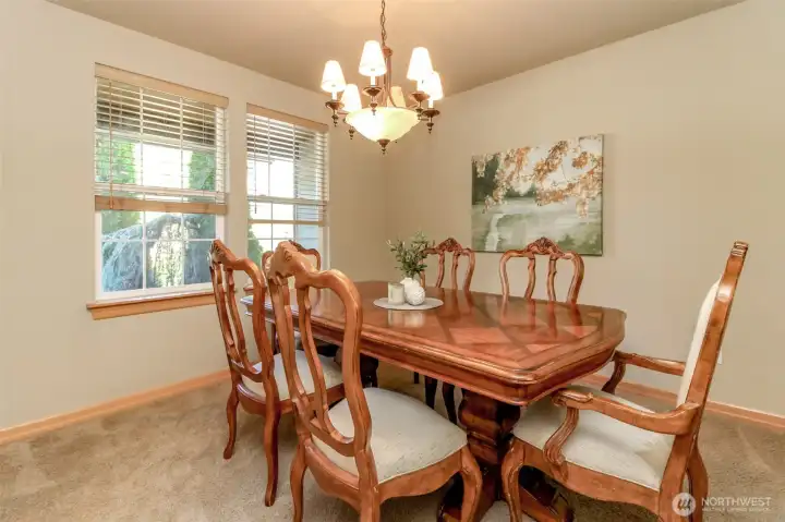 The formal dining room is off the front entry across from the den. These windows overlook the front covered porch.
