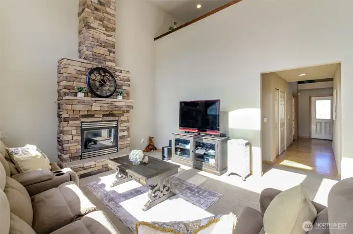 Beautiful propane gas fireplace is the focal point of the family room. 20' ceilings with floor to ceiling brick  stonework.