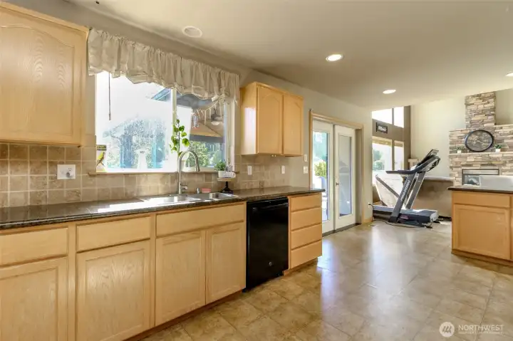 French doors at the end of the kitchen leads to the covered patio and backyard.