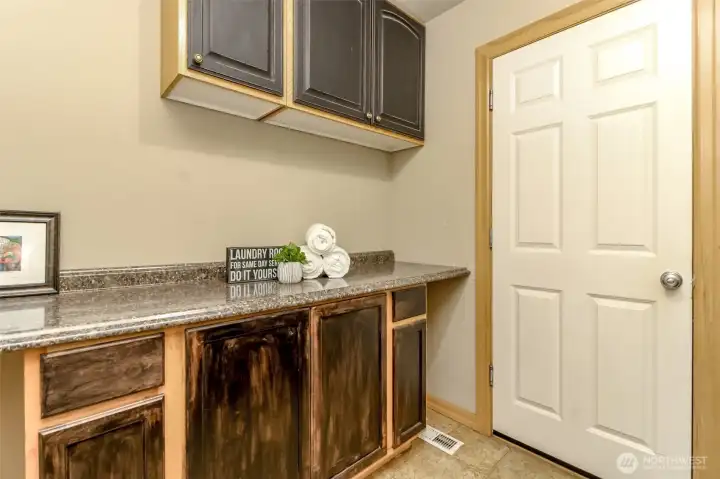 These cabinets and folding counter are across from the washer and dryer.