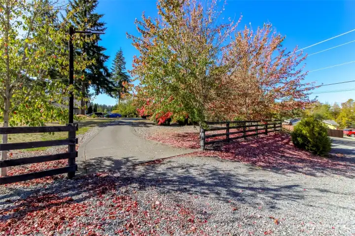 Beautiful fenced and treed entry to fully paved driveway.