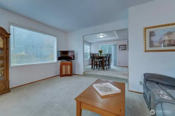 Living room flows to dining room where you can also exit to the deck for some sunshine or outdoor dining