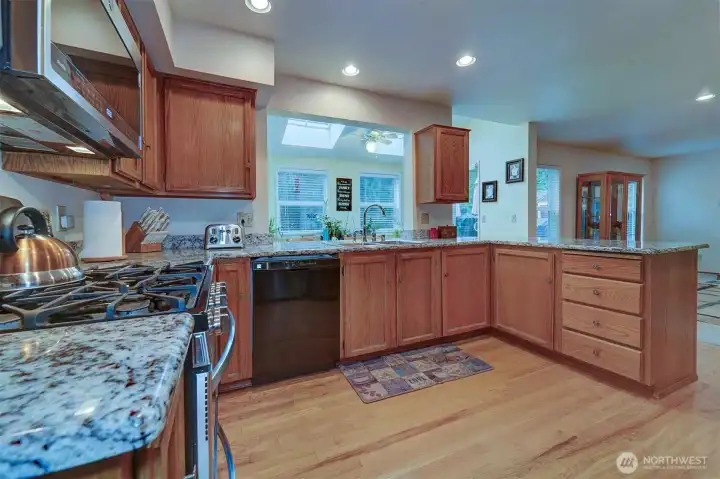 Granite countertops and wood floors give the kitchen that updated look. Plenty of storage space. Gas stove/oven, built-in microwave.