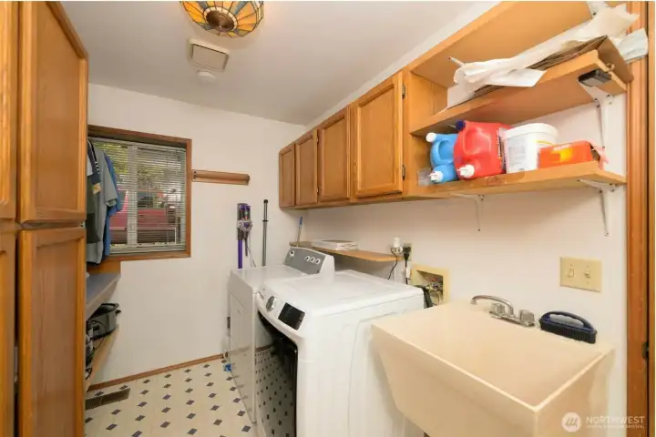 Laundry / Utility room with lots of built in storage, hanging area, shelving and utility sink. Laundry / Utility room with lots of built in storage, hanging area, shelving and utility sink.