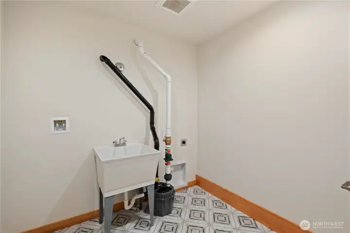 Large laundry room with utility sink.