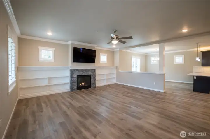 Quality finishes and upgrades are found throughout the home. Windows have louvered shutters, luxury vinyl plank flooring -- added elegance of custom crow molding and built-ins around the fireplace.