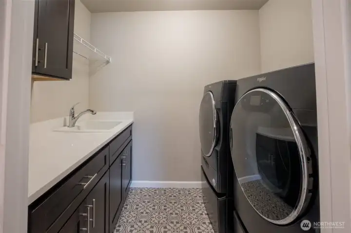 Laundry room rounds out the upper floor - conveniently placed, generously sized washer/dryer set on pedestals, utility sink and great storage.