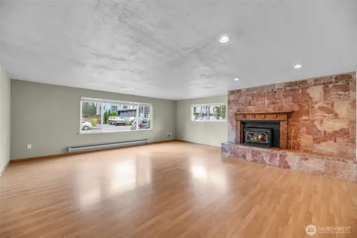 Notice the windows in the large family room with beautiful wood fireplace