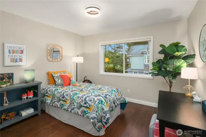 Fourth upstairs bedroom featuring beautiful hardwood floors.