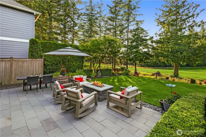 A bluestone patio with firepit completes your backyard paradise.