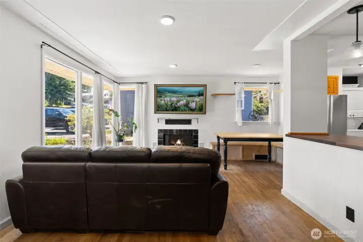 living room with large windows and wood burning fireplace