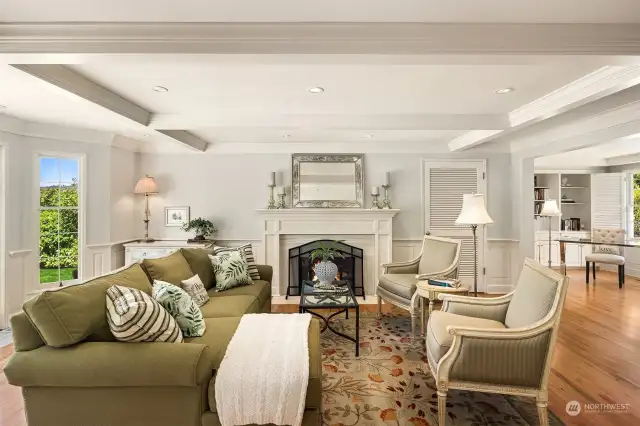 Enjoy the formal living room with a cozy fireplace, satin millwork and a box beam ceiling.  Wonderful space to enjoy a book or entertain your guests.