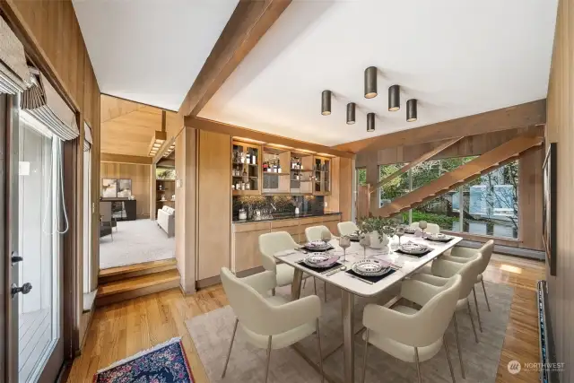 Centrally located in the middle of the house is the large dining room with custom built in buffet. The wood floors, hydronic radiant heating & exposed beams continue throughout with the French door leading out to the deck- all with the gorgeous waterfront views.