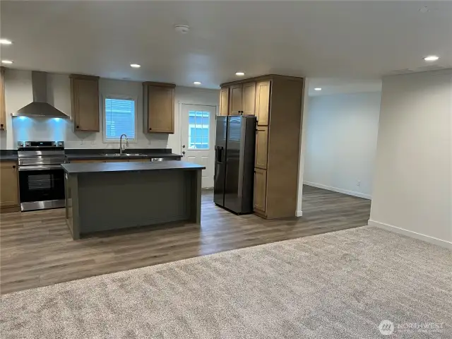 Very open concept looking from living room to kitchen and dining room.