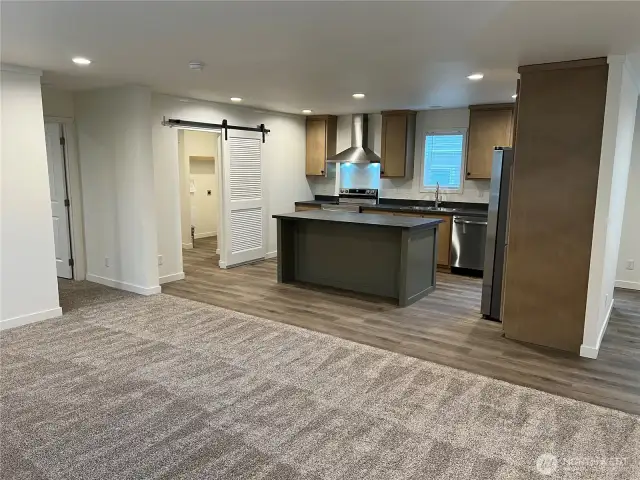 Living room looking towards primary bedroom entrance.