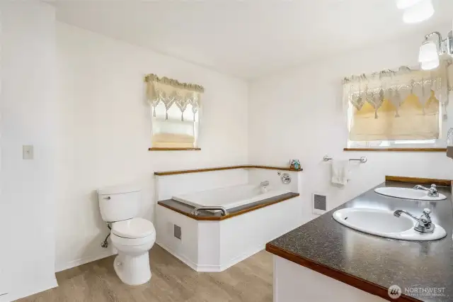 The primary suite includes a jetted tub and double vanity