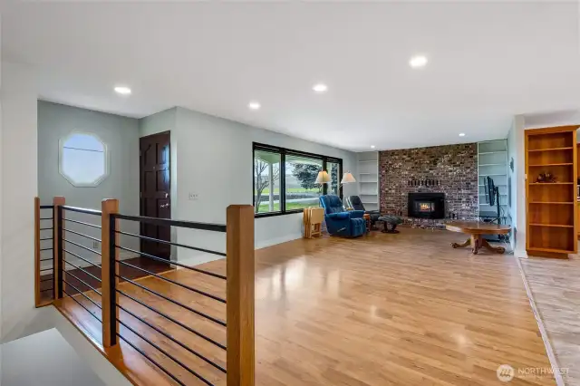 A spacious living room with a timeless brick fireplace