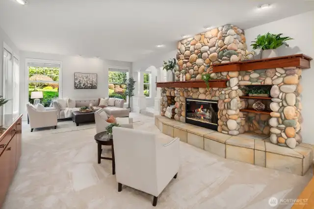 The great room off the kitchen has a stunning rock fireplace.