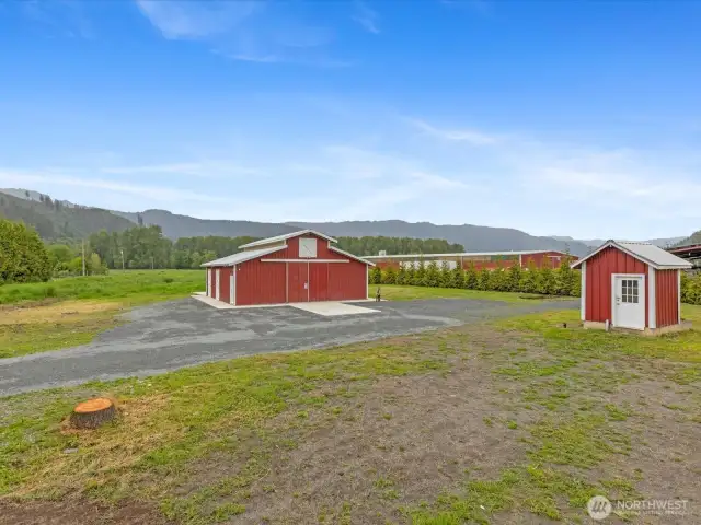 Large barn w/ upper storage area - clean, now has full electrical!  Well pump house on right.