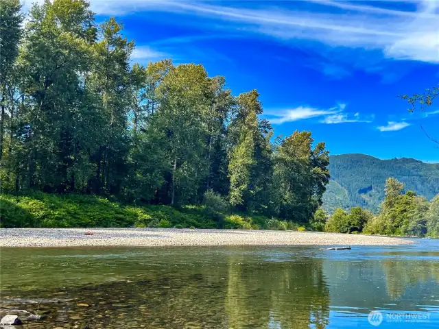 a view from the riverbed on the far end of the property