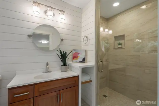 Primary ensuite bathroom with penny tiles, custom cabinets and beautiful tile surround.