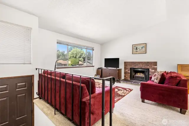 Living room with Vaulted Ceiling and Fireplace.