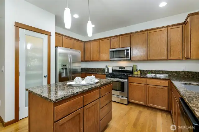 Kitchen with slab granite, pantry, and gas cooktop