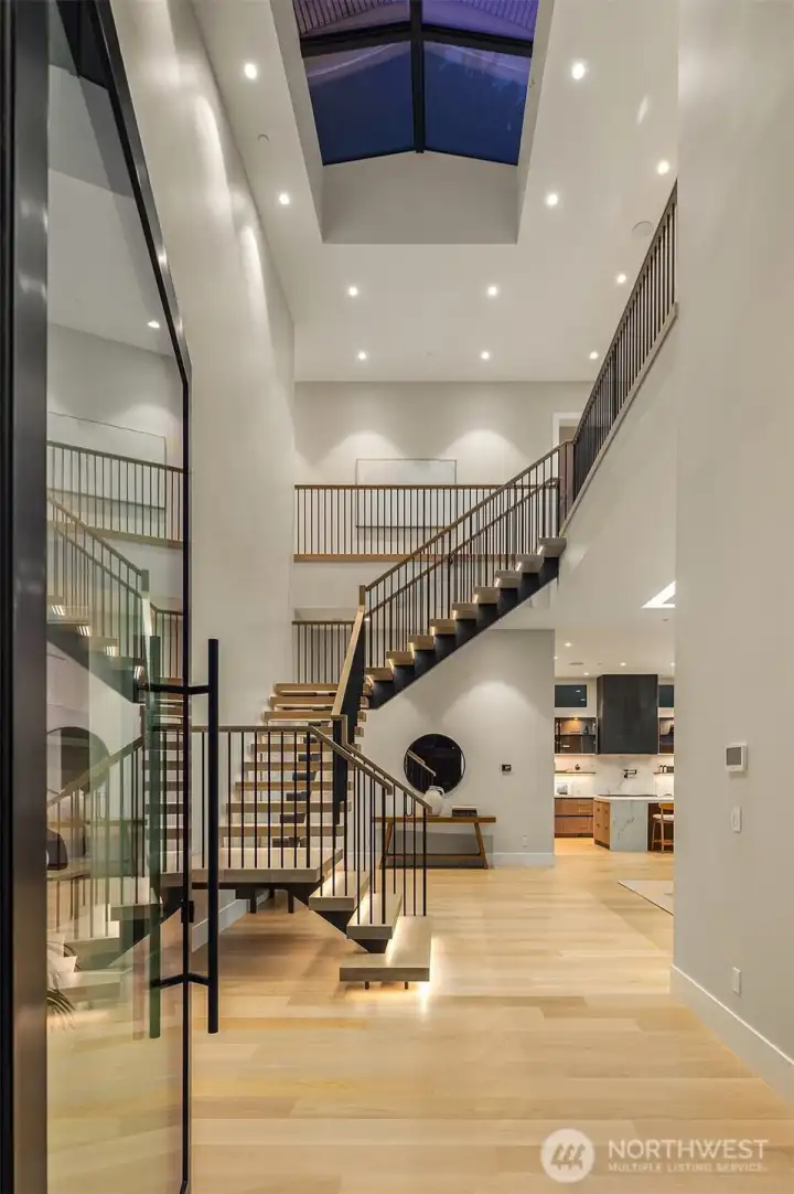 Step through a custom pivot glass door into a masterpiece by Chaffey Custom Construction and McCullough Architects
