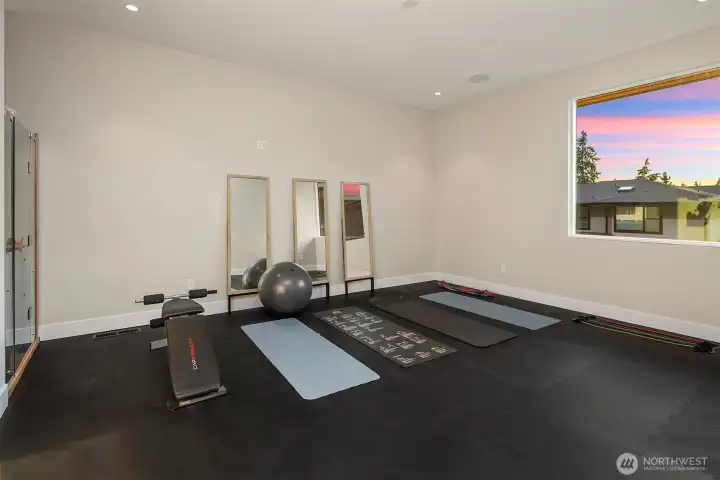Fitness room with synthetic rubber flooring and Clearlight Infrared Sauna