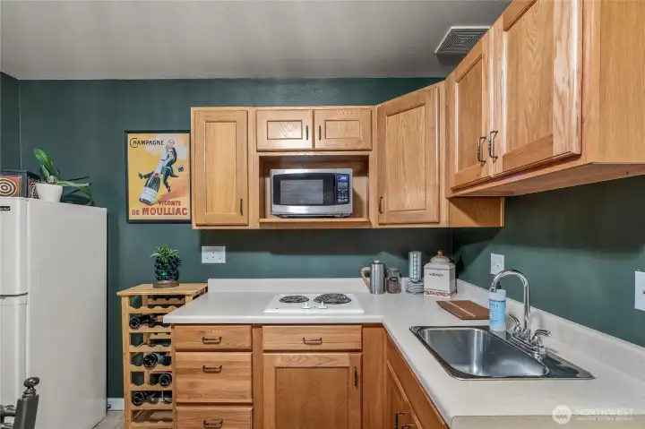 Compact kitchenette with storage and appliances—ideal for guests or multi-gen living