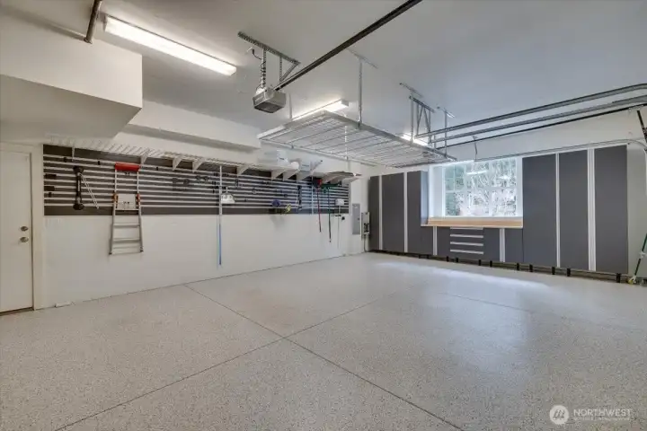 3 car garage, epoxy floors, built in storage