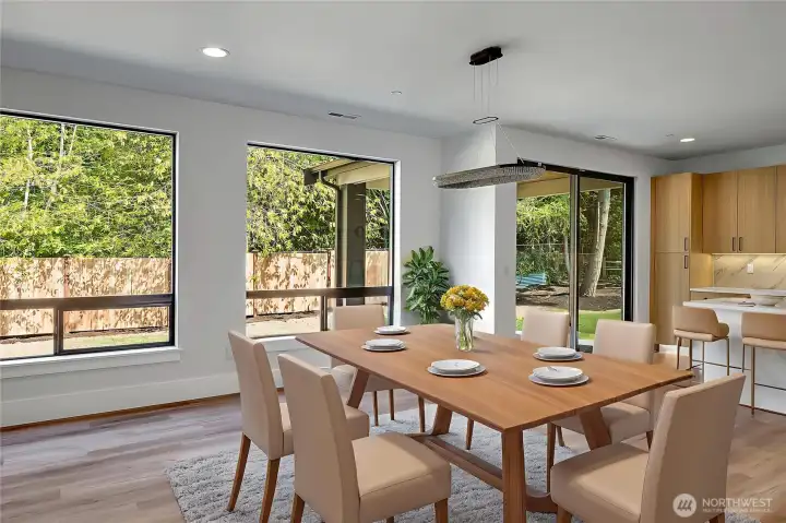 Openly lit dining space (virtually staged, photo of similar home in separate community)