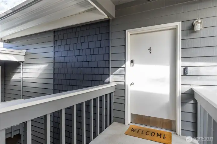 Top floor end unit has a covered entrance with a convenient keyless lock