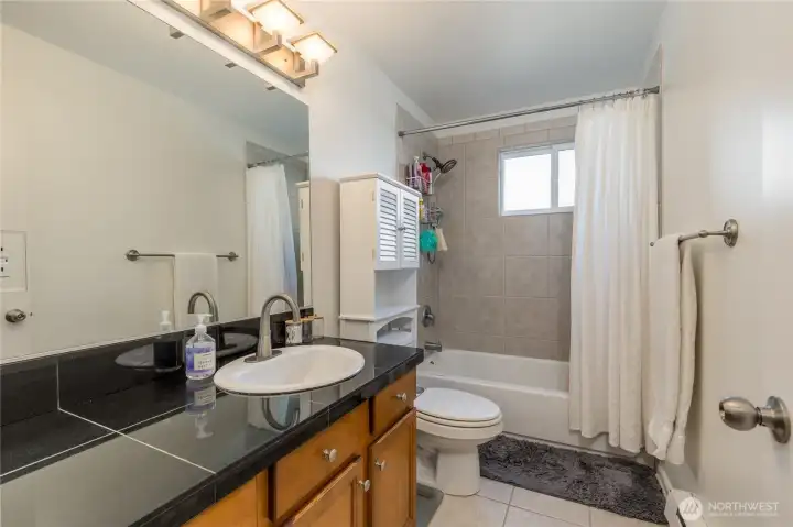 Refresh in the generous full bath with custom tile work. Added convenience with a stackable washer/dryer located just outside the door.