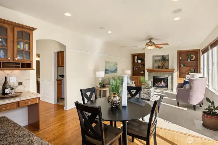 The perfectly sized casual dining area opens to the family room — notice the handy built-in desk tucked just off the kitchen.