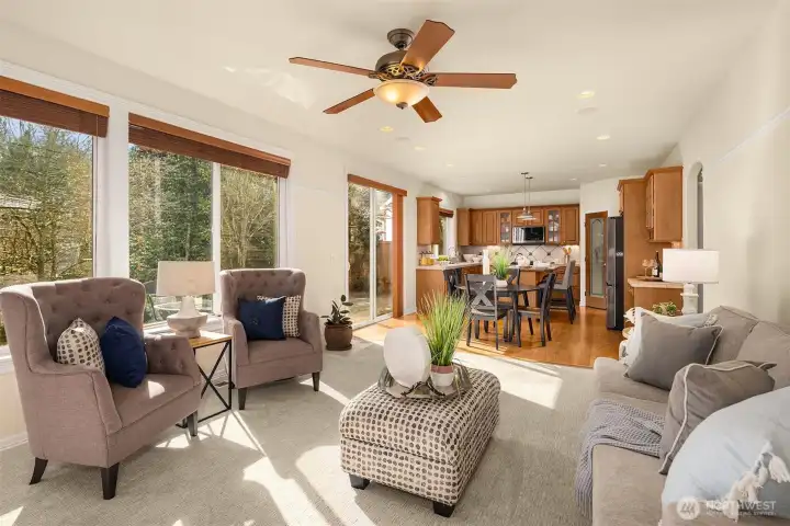 The heart of the home — bright, open, and connected to the kitchen and casual dining area, all with greenbelt views.