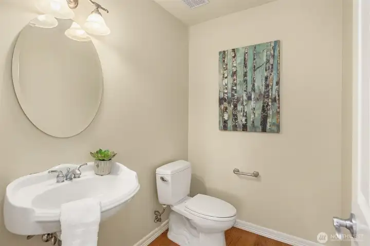 The main floor powder room features a classic pedestal sink.