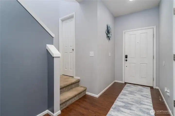 Entry with half bath on stair landing