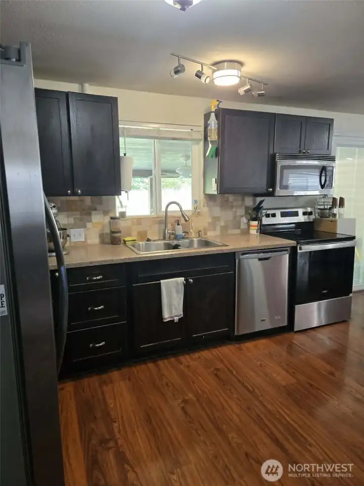 Sink, dishwasher, stove, microwave.  All appliances stay