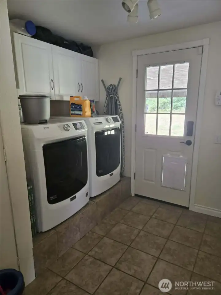 Washer and dryer stay.  This door goes out to the back patio and yard