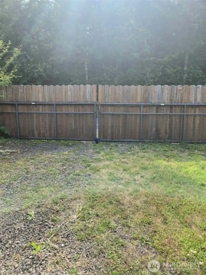 RV gate opens into graveled parking spot