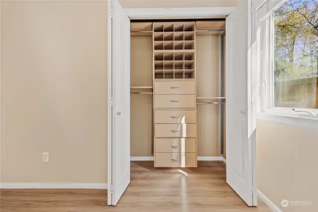 Custom built-in closet organizer in primary bedroom.