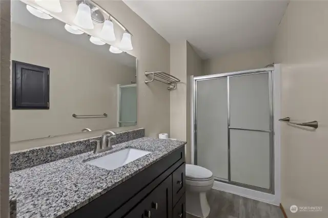 En-suite off of the Primary bedroom has gorgeous counters, walk in shower, long vanity and ample storage.