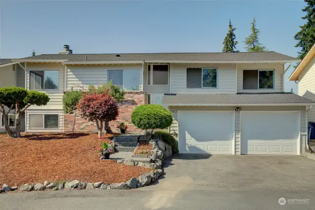 Plenty of parking for multiple cars in driveway and oversized 2 car garage