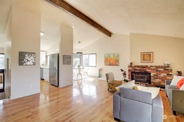 Vaulted ceilings open up the living and dining areas with newer hardwood floors