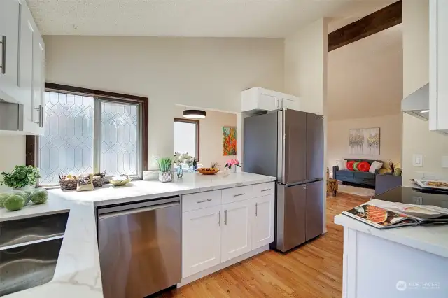 Brand new kitchen with quality stainless appliances, quartz counters and wood shelving.